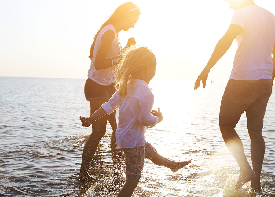 Family paddling in the sea