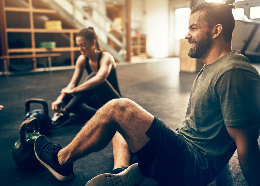 Couple taking a rest in the gym